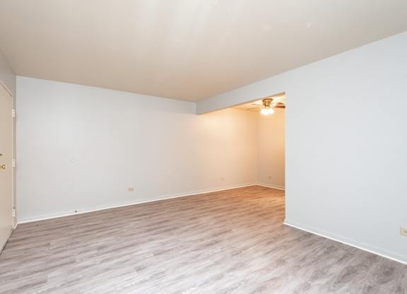 A room with a light on and a door on the left.