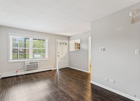 a bedroom with hardwood floors and grey walls at The Hinsdale, Illinois