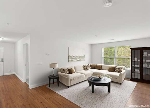 A living room with a white couch and a coffee table.