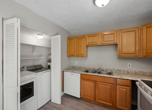 a kitchen with white appliances and wooden cabinets at Fort Collier Terrace, Winchester, 22601