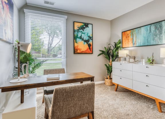 a home office with a desk and a dresser at The View Apartments St Charles, St Charles, IL