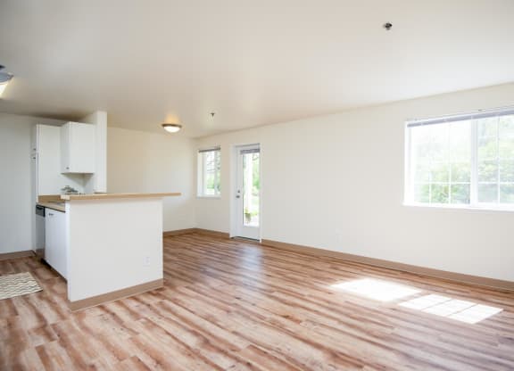a living room with a kitchen and a hard wood floor at Murrayhill Park, Oregon