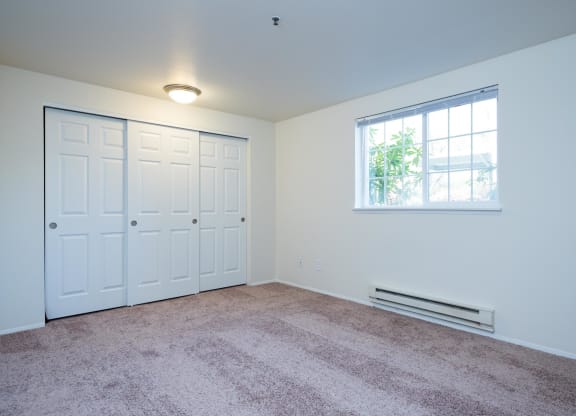 a bedroom with two closets and a window and carpet at Murrayhill Park, Beaverton, OR
