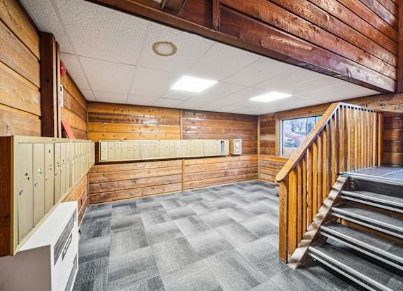 A wooden staircase with a wood railing.