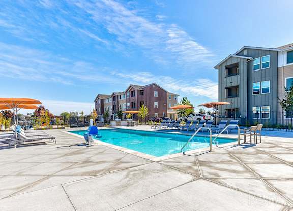 A swimming pool surrounded by apartment buildings.