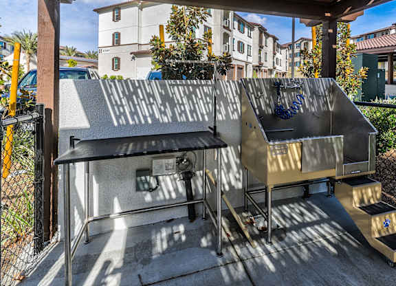 A metal structure with a black roof and a yellow railing.
