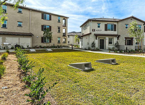 A grassy area in front of a building with a number 43337 on it.