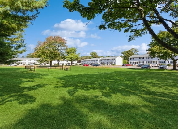 a park with green grass and the apartment buildings in the backgroundat Fox Hill Commons, Vernon, CT, 06066