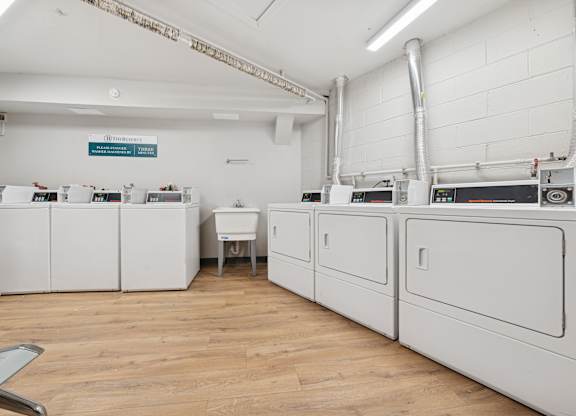 A room with white cabinets and a wooden floor.