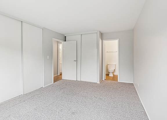 Bedroom with white walls with two doors