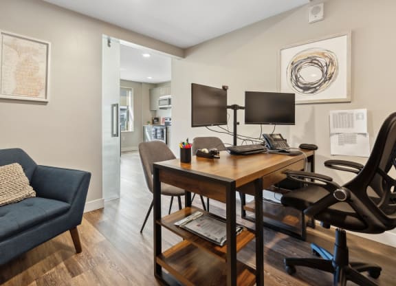a home office with a desk and two monitors at The Rowe, Grand Rapids