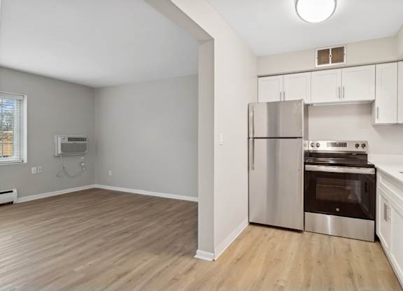 A kitchen with a stainless steel refrigerator and oven.