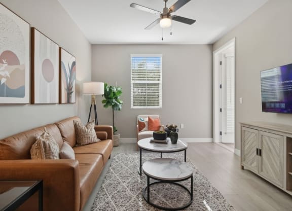 a living room with a couch and a ceiling fan at Arrive Temecula