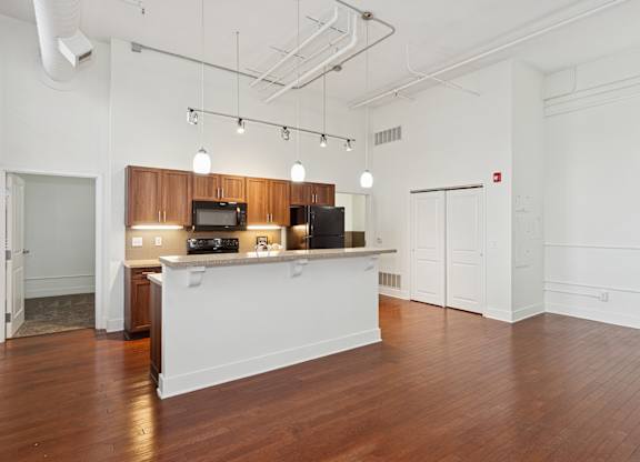 A kitchen area with a counter and cabinets.