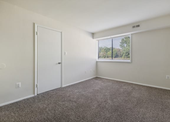 Bedroom with carpet and a window at Briarwood Apartments, Dumfries, VA, 22026