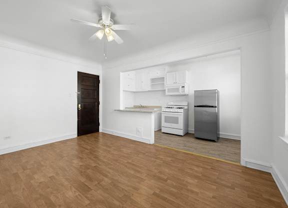 A room with a ceiling fan and a kitchenette at Pleasant Oak Apartments, Oak Park