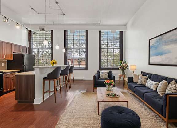 A living room with a blue couch and a coffee table.