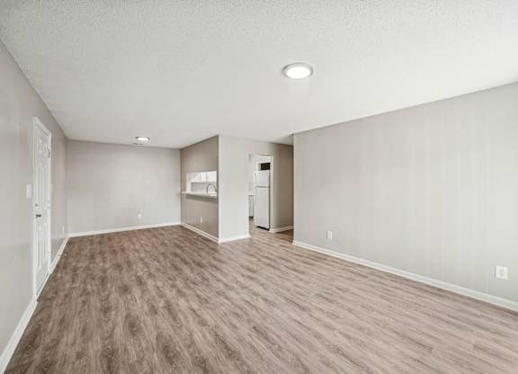 A room with light brown flooring and white walls.