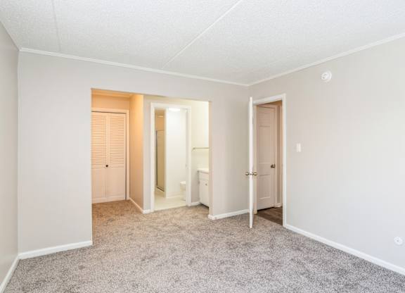 A room with a carpeted floor and white walls.