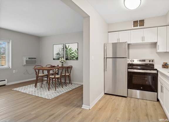A kitchen with a table and chairs in the middle of the room.