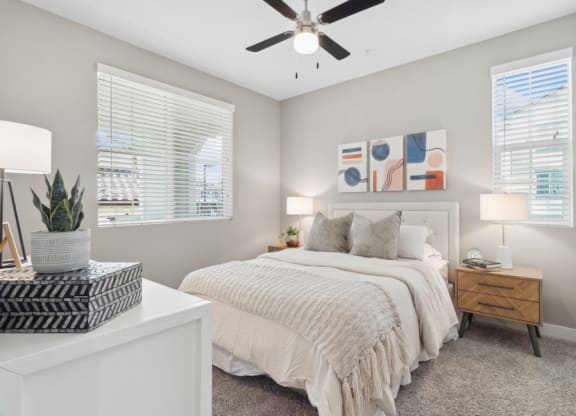 a bedroom with a bed and a ceiling fan at Arrive Temecula