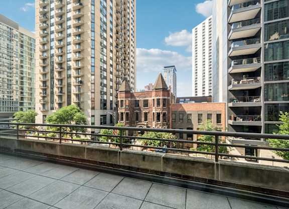 A view of a cityscape with modern buildings and a bridge.