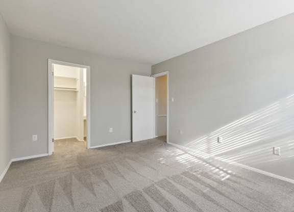 the living room of an apartment with white walls and carpet at Briarwood Apartments, Dumfries, 22026