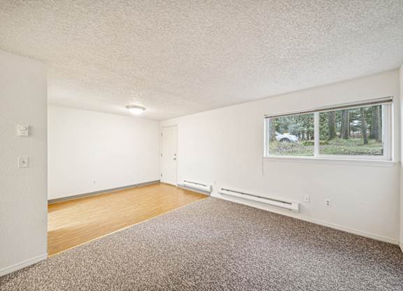 A room with a window and a car parked outside.