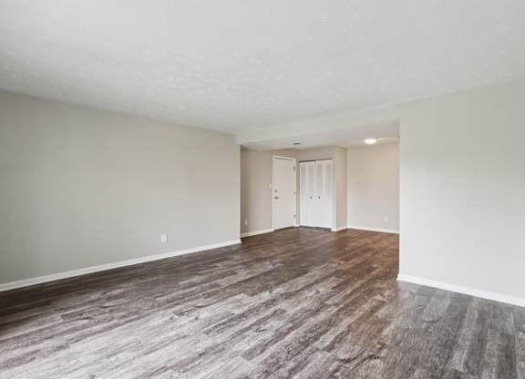 A room with a wooden floor and white walls.