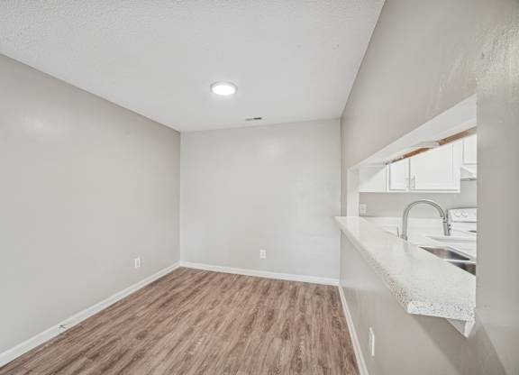 A room with a wooden floor and white walls.
