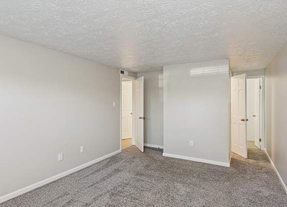 A room with carpeted floor and white walls.