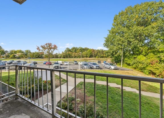 the view of the parking lot from the balcony of a building with a metal railing at Briarwood Apartments, Dumfries