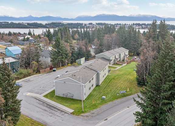 A view of a residential area with houses and trees.