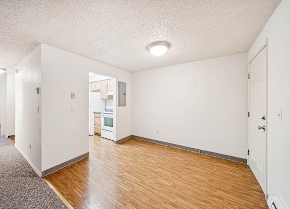 A room with white walls and wooden flooring.