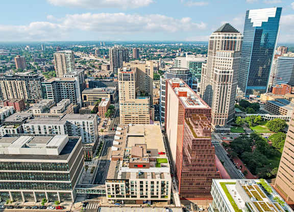 A cityscape with various buildings and a clear sky.