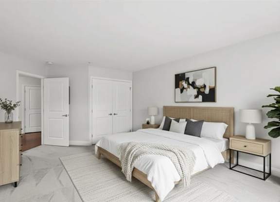 A bedroom with a large bed, a wooden nightstand, and a painting on the wall.
