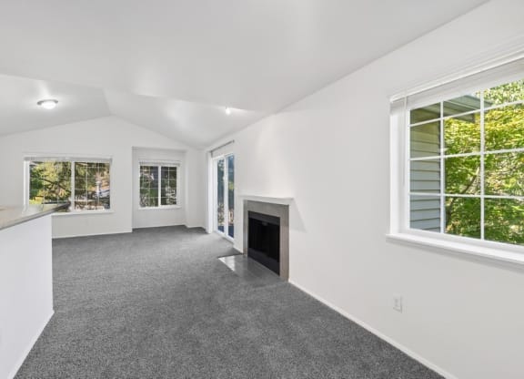 the living room and kitchen of a house with a fireplace