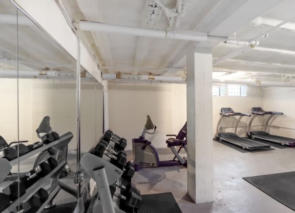 a gym with treadmills and other exercise equipment