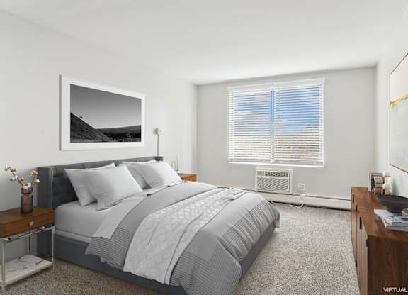 A bedroom with a large bed and a painting on the wall.