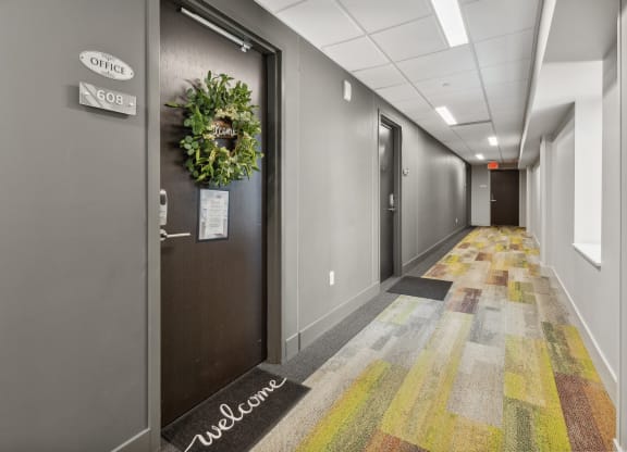a hallway of elevators and doors in an office building at The Rowe, Michigan