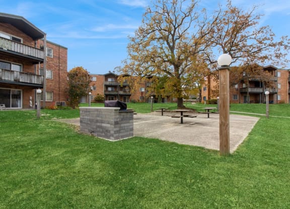 our apartments have a park with a picnic table and a fire pit at River Oaks, North Aurora, Illinois