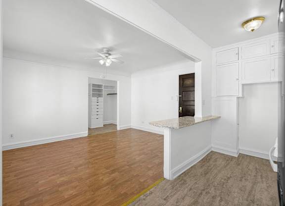 A room with wooden floors and white walls at Pleasant Oak Apartments, Illinois