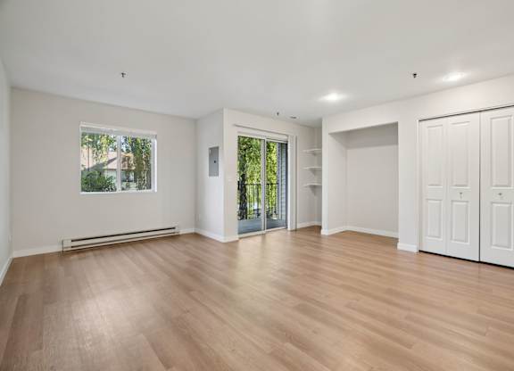 A room with wooden floors and white walls.