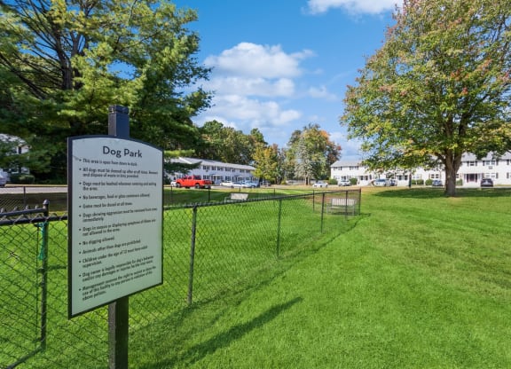 a dog park with a dog park rules sign in front of a fenceat Fox Hill Commons, Vernon, CT, 06066