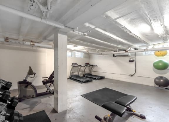 A gym with weights and a treadmill