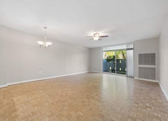 A room with a wooden floor and a ceiling fan.