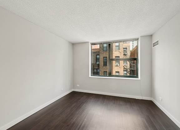 Empty room with a window showing a city view.