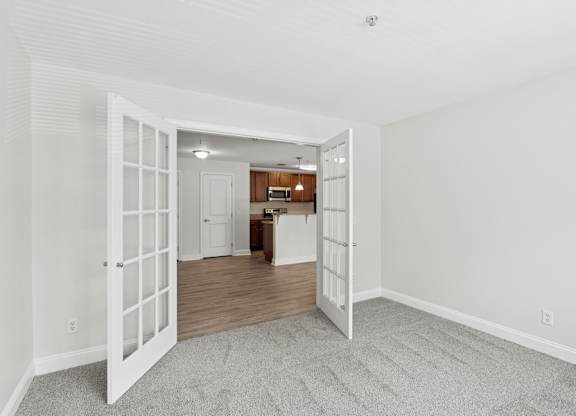 A room with a white door leading to another room.