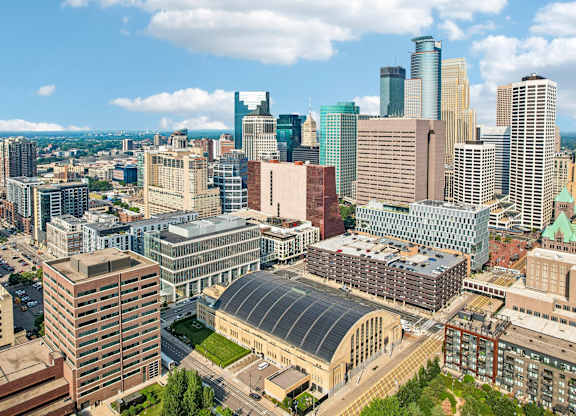 A cityscape with a mix of modern and older buildings under a clear sky.