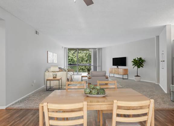 A dining room with a wooden table and chairs.